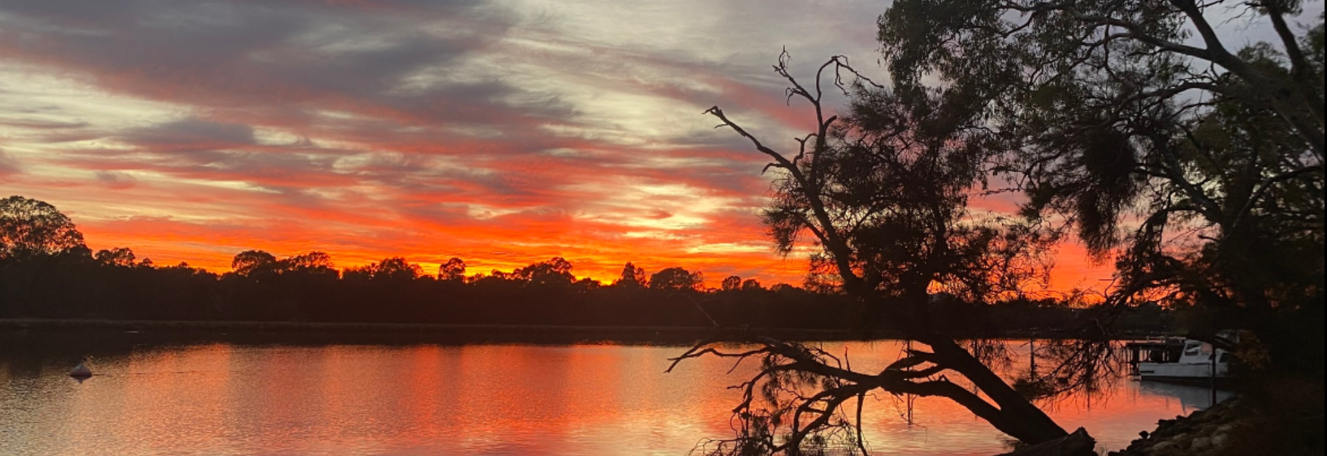 Stunning sky at dawn, reflecting on the river. View captured from the front of Sup Tonic Headquarters.